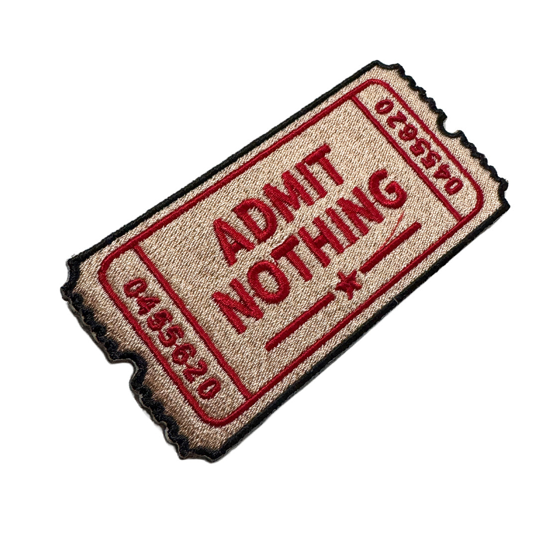 Patch resembling a 'Admit Nothing' ticket on a white background