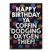A birthday card with a black background featuring colorful birthday cakes and white text that reads 'HAPPY BIRTHDAY YA COFFIN DODGING OXYGEN THIEF!'.