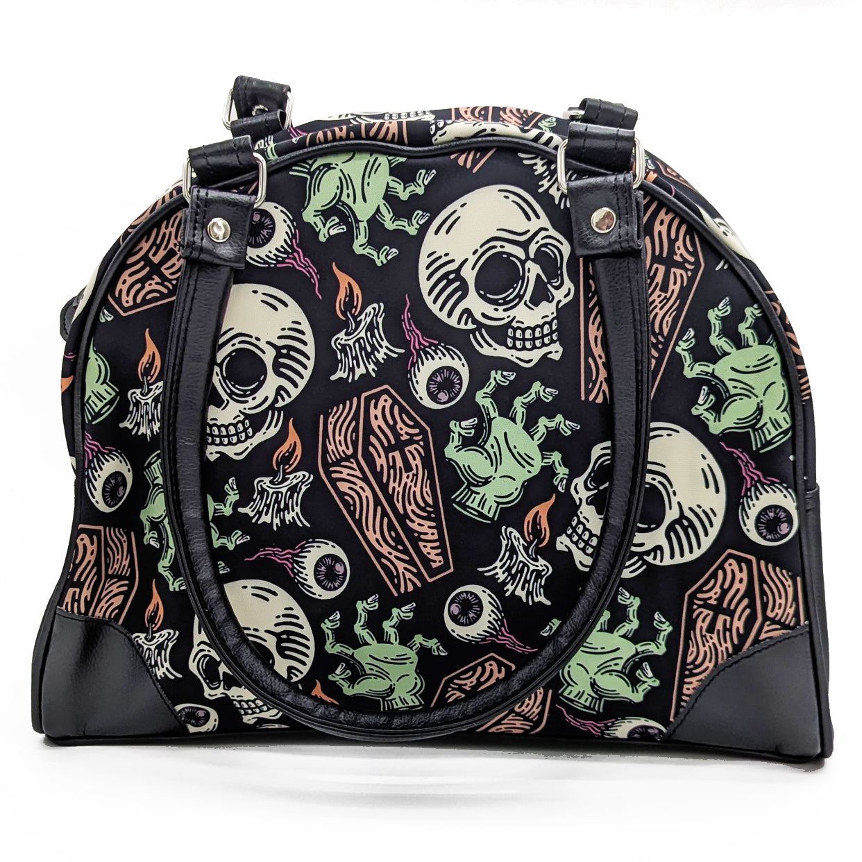 A black purse with a bold pattern featuring skulls, coffins, and eyeballs in orange and green shades.