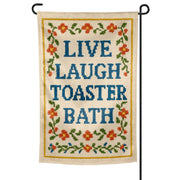 Decorative garden flag with 'Live Laugh Toaster Bath' text and floral designs on a white background.