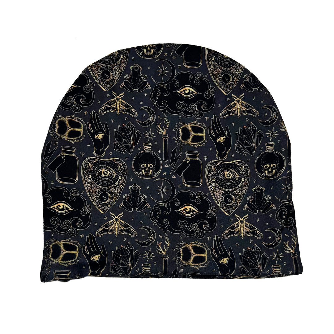 Black beanie with gold and black symbols on a white background