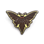 Moth-shaped enamel pin with a yellow border on a white background