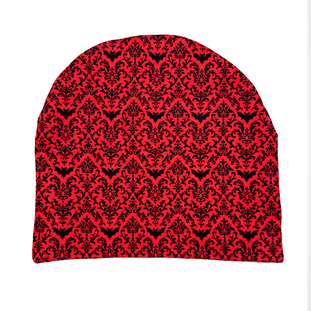 Red beanie with black floral pattern on a white background