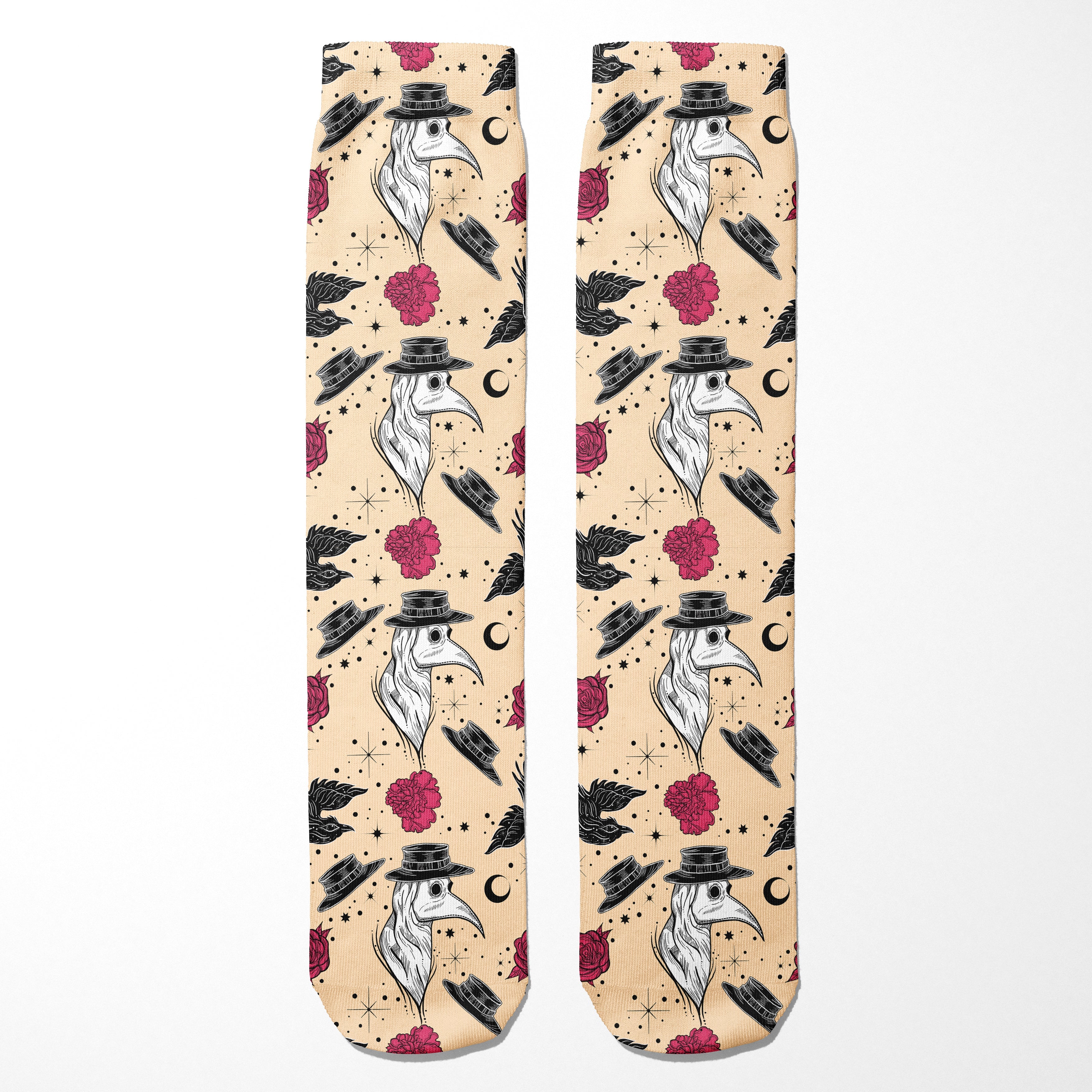 Two socks with a pattern of birds wearing hats and flowers on a beige background.
