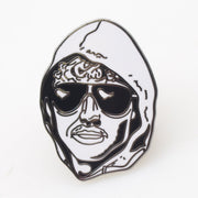 This image displays a striking metal enamel pin featuring a bold, black and white illustration of Ted Kaczynski, also known as the Unabomber. The pin measures approximately 1.